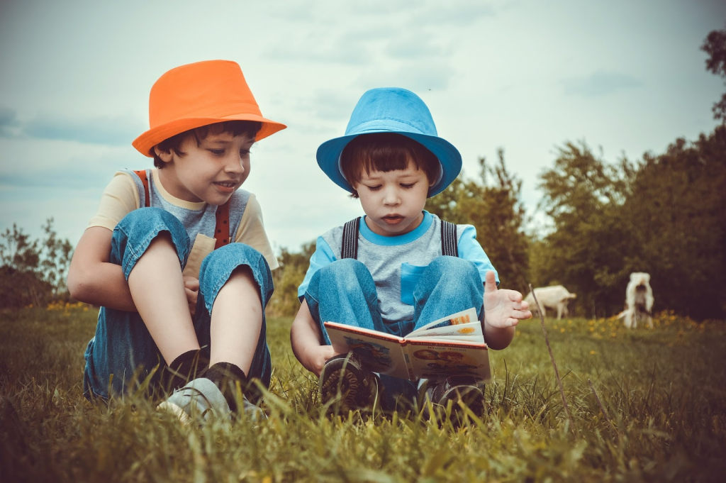 Picture of two children reading a book together
